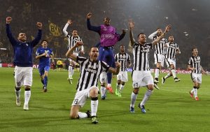 Players of Juventus celebrate after their Champions League round of 16 second leg soccer match against Borussia Dortmund in Dortmund